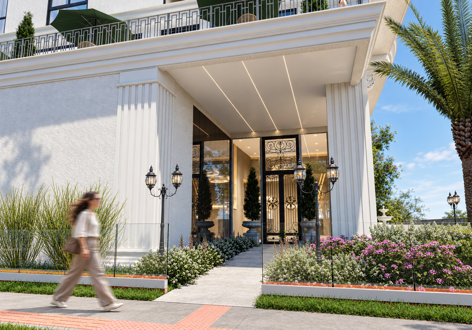 Entrada do Neomare Home Club com colunas neoclássicas, portas ornamentadas e jardins floridos